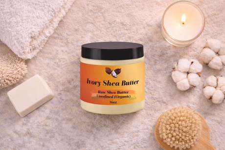 Jar of Ivory Shea Butter with a candle, soap, and brush on a textured surface