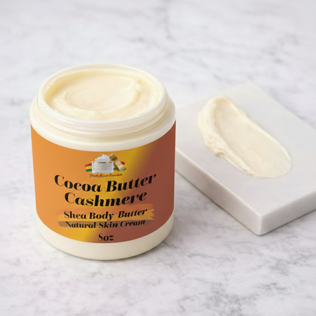 Jar of Cocoa Butter Cashmere shea body butter on a marble surface
