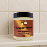 Jar of coconut cream shea body butter on a tiled bathroom shelf