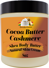 Jar of Cocoa Butter Cashmere Shea Body Butter with a black lid on an orange label.